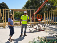 Board member, Judi Carr, talks with a worker on the project