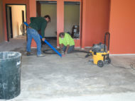 Keith, left, and Paul from "All States Flooring" in Fargo prepare the concrete for new flooring