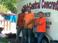 Travis Double (far right), Site Supervisor for Marcus Construction, and two construction workers from Mid‑Central Concrete agree to stop for a photo.